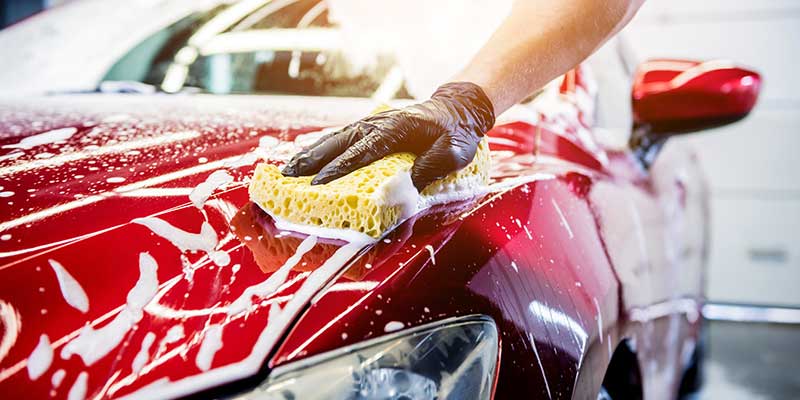 service person washing car